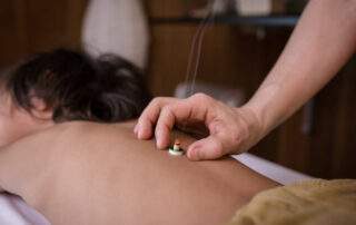 Practitioner using gentle touch to assess a patient