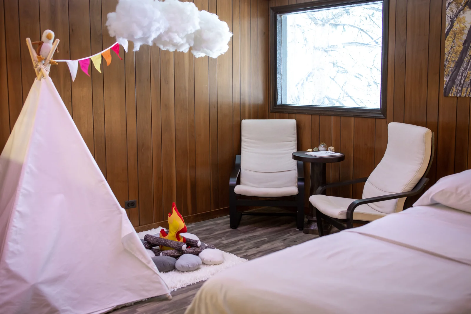 Treatment room with a small play tent and toys beside the table.