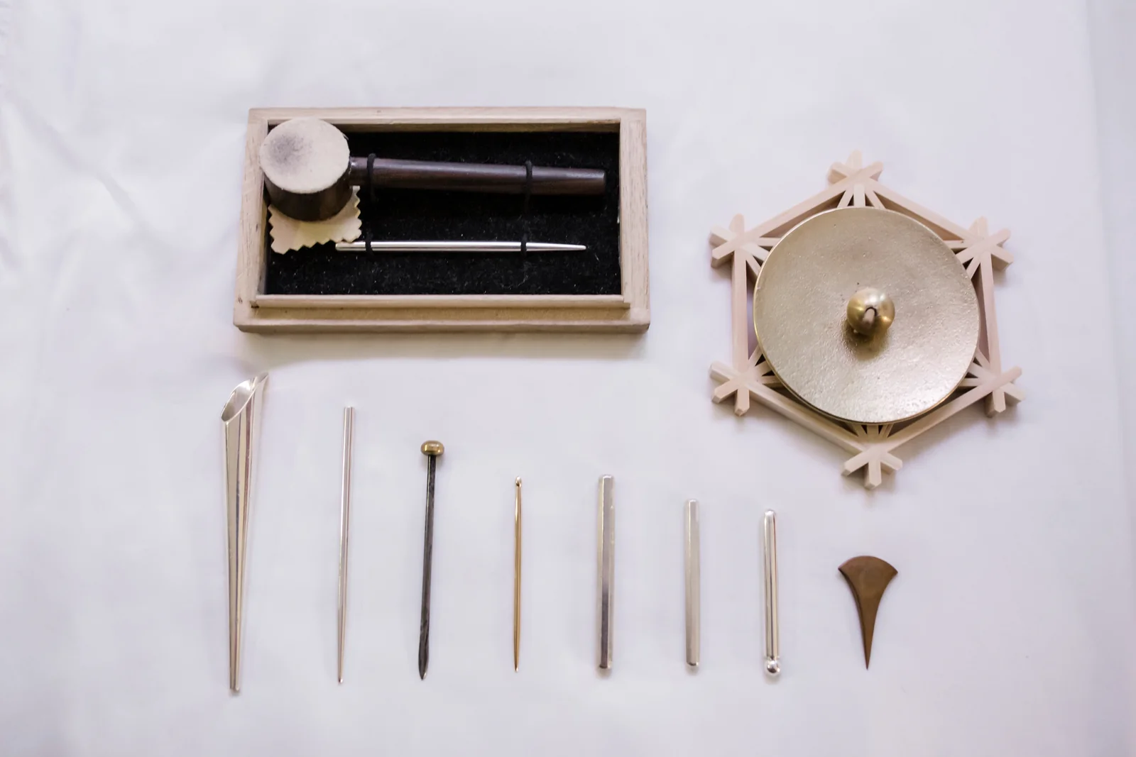 Japanese acupuncture hand tools arranged beside an incense holder.